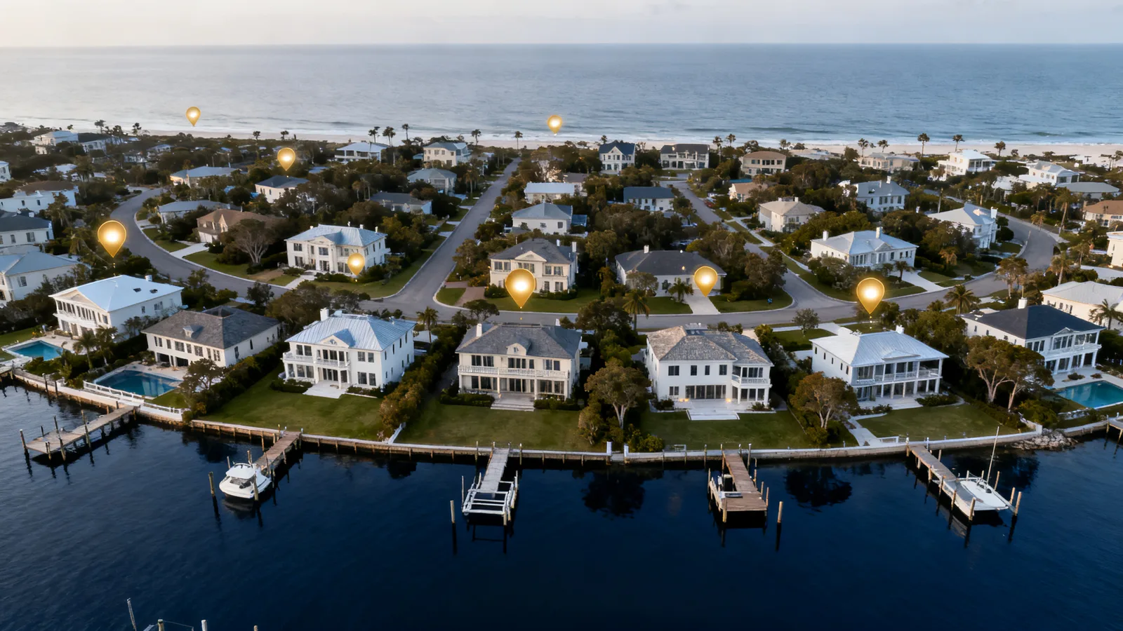 Aerial view of an affluent coastal neighborhood with glowing markers over specific estate homes