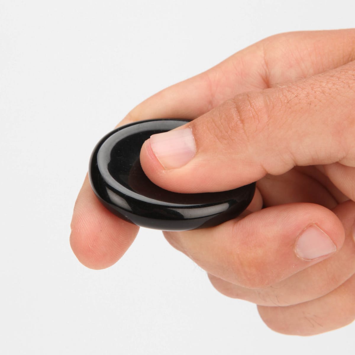 A thumb rubbing a worry stone