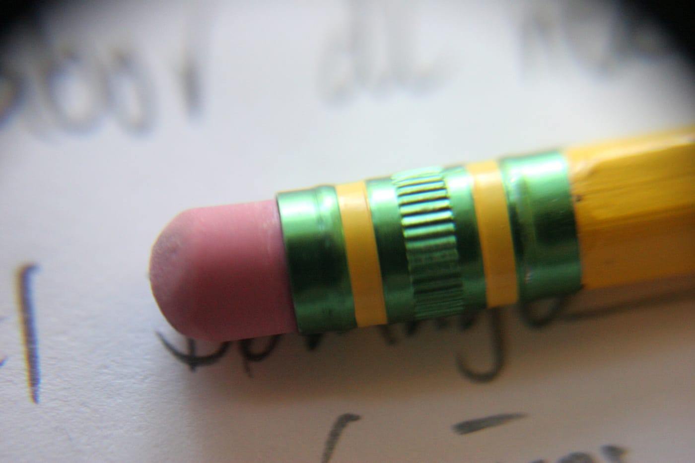 A pencil eraser over handwriting